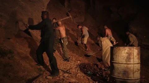 Men mine gold underground. Diamond seekers dig the ground in search of treasures Stock Footage 147452206