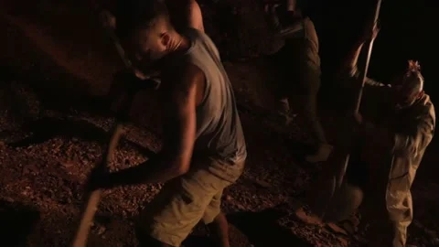 Men mine gold underground. Diamond seekers dig the ground in search of treasures Stock Footage 147453789