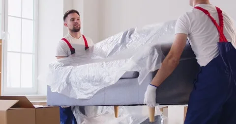 Men Movers Carrying Sofa During Relocation Stock Footage 275830578