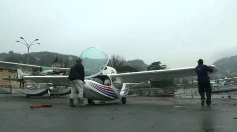 Men moving plane outside hangar  Stock Footage 43317031