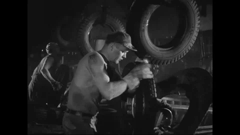 Men moving tires through production line - 1939 Stock Footage 103596695