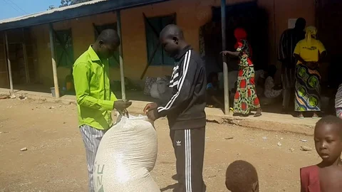 Men Opening a Sack of Grain  co Stock Footage 116624991