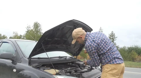Men opens the car hood and visually inspects examines the motor engine, check 库存影片 68685285