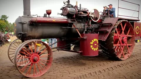 Men operating an old-fashioned steam engine tractor in Waterloo, Ontario. Stock Footage 12156667