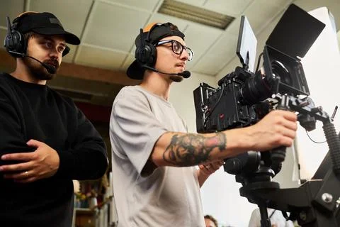 Men Operating Professional Video Camera during Studio Film Production Stock Photos