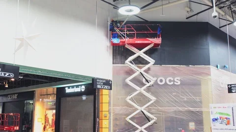 Men paint shoes store facade black on scissor lift timelapse Stock Footage 112592449