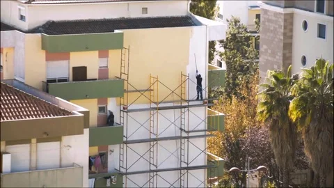 Men paint a wall Stock Footage 69973704
