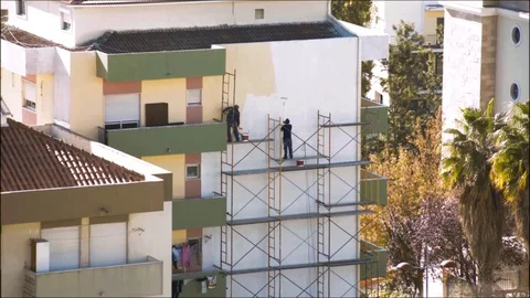 Men paint a wall Stock Footage 69974254