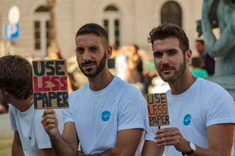 Men with placards saying "Use less paper" in global climate change protest Stock Photos