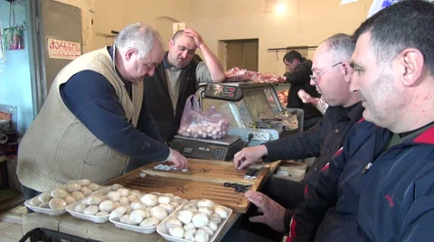 Men play backgammon in butcher shop, Tbilisi Stockbeeldmateriaal 27533334