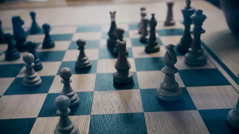 Men play chess at a table with a clock Video stock 118832956