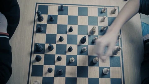 Men play chess at a table with a clock. Stock Footage 118953703