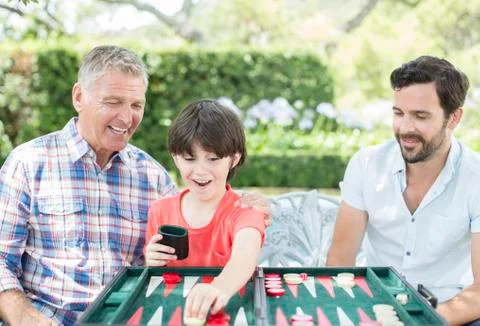 Men playing backgammon outdoors Stock Photos