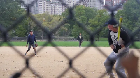 Men playing baseball in Central Park, New York City on an autumn morning. Stock Footage 133004676
