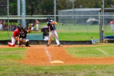 Men playing baseball game. Batter trying to hit a pitch during ballgame on .. Stock Photos