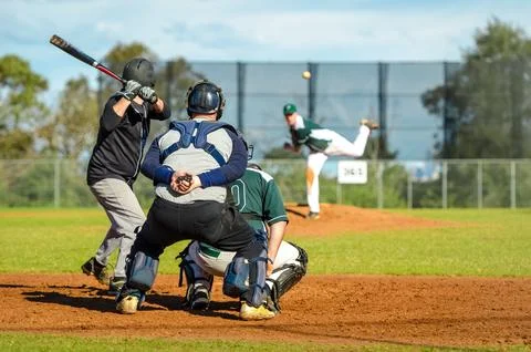 Men playing baseball game. Batter trying to hit a pitch during ballgame on .. Stock Photos