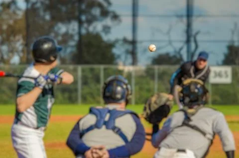 Men playing baseball game. Batter getting ready to hit a pitch during ballg.. Stock Photos