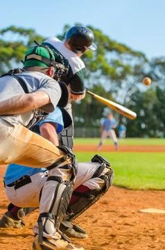 Men playing baseball game. Batter getting ready to hit a pitch during ballg.. Stock Photos