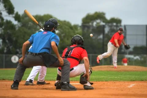 Men playing baseball game. Batter getting ready to hit a pitch during ballg.. Stock Photos