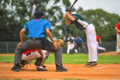 Men playing baseball game. Batter getting ready to hit a pitch during ballg.. Stock Photos