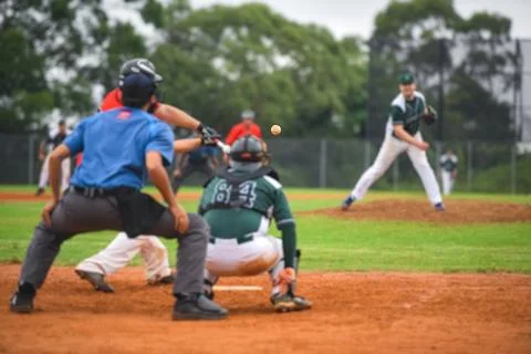 Men playing baseball game. Batter getting ready to hit a pitch during ballg.. Stock Photos