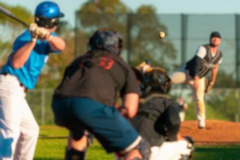 Men playing baseball game. Batter getting ready to hit a pitch during ballg.. Stock Photos