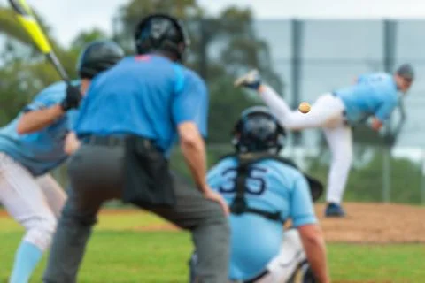 Men playing baseball game. Batter getting ready to hit a pitch during ballg.. Stock Photos