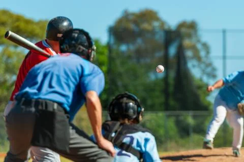Men playing baseball game. Batter getting ready to hit a pitch during ballg.. Stock Photos