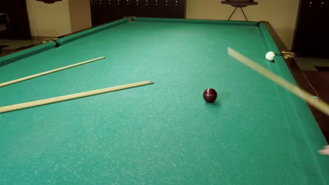 Men playing billiards, hitting balls with cue into pockets on billiard table. 4K Stock-Footage 109411642