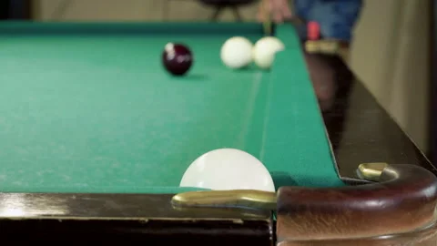 Men playing billiards, hitting balls with cue into pockets on billiard table. 4K 库存影片 109452559