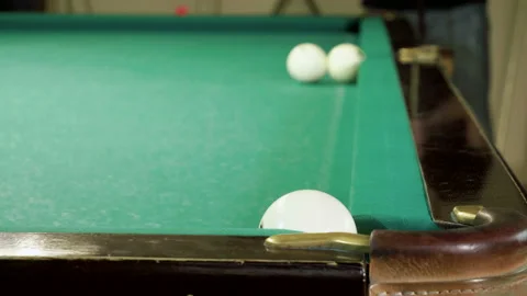 Men playing billiards, hitting balls with cue into pockets on billiard table. 4K Stock Footage 109452579
