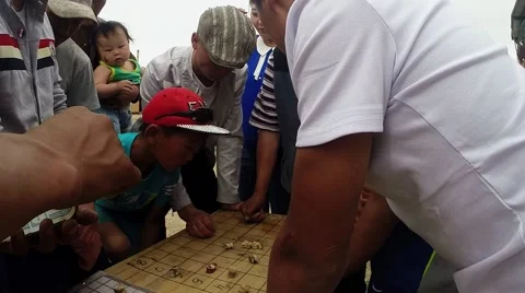 Men Playing Board Game During Break in Holiday View From Behind the Backs Stock Footage 62569193