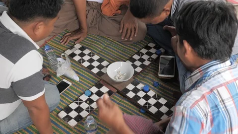 Men playing board game with shell dice,Mandalay,Burma Stock Footage 100617100