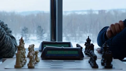 Men playing chess with a clock at the table Stock Footage 85392324