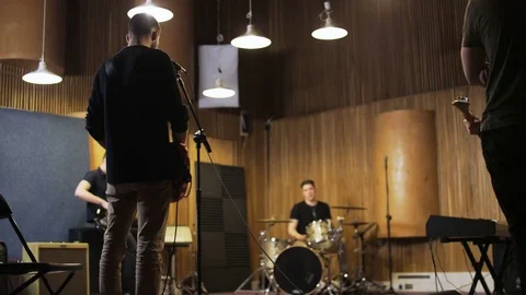 Men Playing Guitars and a Drum Set Stock Footage 72223388