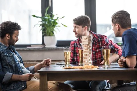 Men playing jenga game Stock Photos