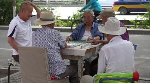 Men playing Mahjong on sidewalk tight shot, Jiayuguan Stock Footage 47457415