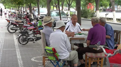 Men playing Mahjong on sidewalk wide shot, Jiayuguan 스톡 동영상 47452005