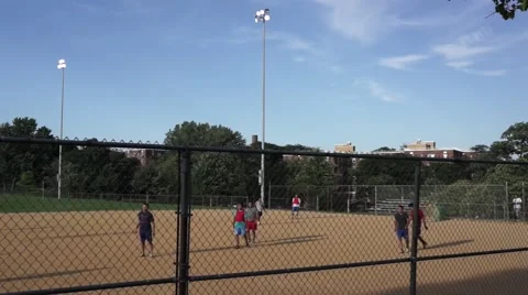Men playing soccer on a baseball field Stock Footage 53084063