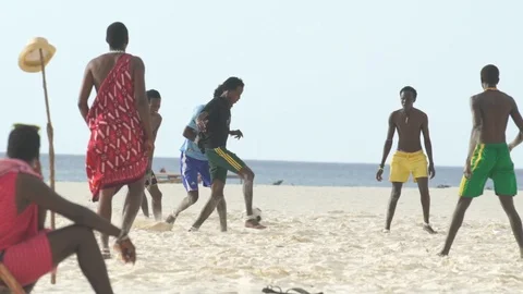 Men playing soccer on sand at beach Stock Footage 85777793