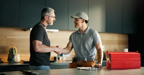 Men, plumber and client with handshake in kitchen for solution, maintenance.. Stock Photos