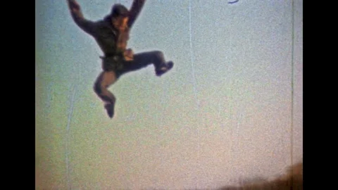 Men practice martial combat arts, jumping on blue sky background. Mastery Stock Footage 276428877