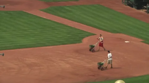 Men preparing baseball diamond for upcoming game Stock Footage 56947391