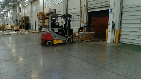 Men preparing to load pallet for shipment Stock Footage 89513813