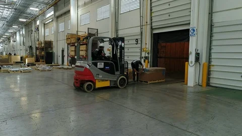 Men preparing to load pallet for shipment Stock Footage 89514534