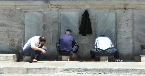 Men preparing for prayer at outdoor ablution taps in Istanbul Stock Footage 321047422