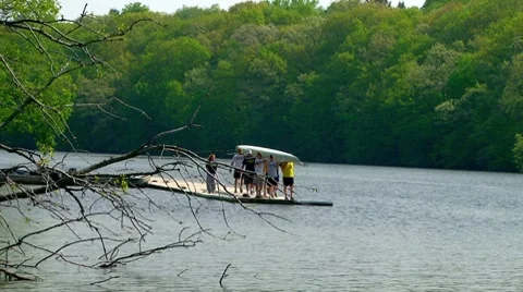 Men preparing to set their scull into the water. Stock Footage 7900032