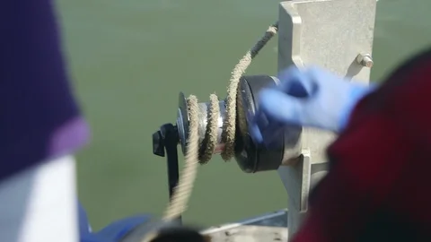Men pulling rope on a boat Stock Footage 93528163