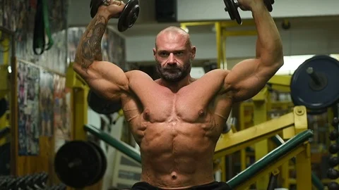 Men pumping up shoulders muscles workout fitness and bodybuilding Vídeos de archivo 119076734