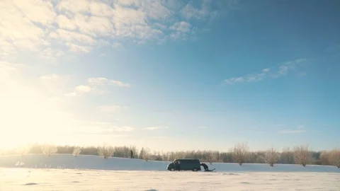 Men push broken car with engine problems in sunny winter day Stock Footage 83267761